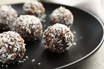 Tasty chocolate candies with nuts on light table, closeup