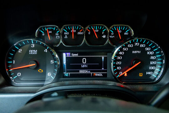 truck dashboard with warning lights, check engine and low tire warning lights