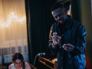 A group of friends shares conversations in a cozy setting during an indoor gathering with warm, ambient lighting.