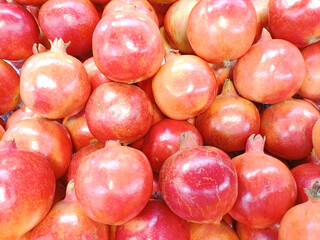 Pomegranate fruit isolated ripe pomegranates with juicy seeds visible, for sale at a market