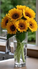 Fototapeta premium Sunflowers rest in a glass jar on a marble countertop, enhancing a lively kitchen setup with jars filled with various ingredients nearby