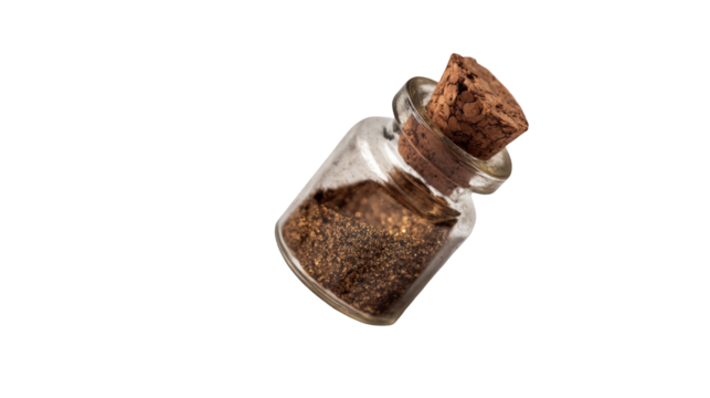 Small glass jar with a cork lid, filled with a dark brown powder