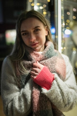 Portrait of a young beautiful long-haired girl in the night city.