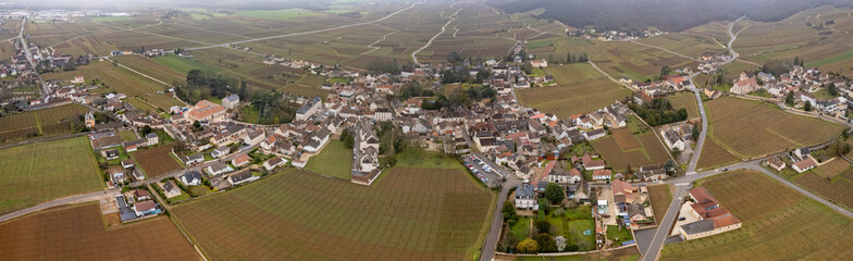 An aerial panorama view around the old town in the city Gevrey-Chambertin in France on a cloudy morning in early spring