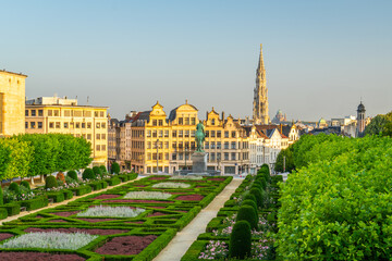 Empty Mont des Arts Square Early Morning. Green Garden, Clear Sky and Spire of Town Hall. City of Brussels, Belgium. Golden Hour