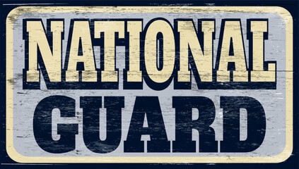 Fototapeta premium Aged and worn retro national guard sign on wood
