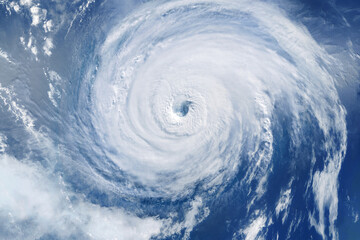 powerful hurricane seen from space with a clearly defined eye, showcasing the immense force of nature, swirling clouds, and the dramatic beauty of extreme weather over the ocean