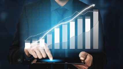 A businessman interacts with a tablet displaying digital graphs and data analytics, representing growth and success in modern business operations and decision-making. Copula