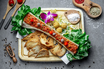 Tasty dish with fresh herbs. A lively spread of meat sauce, fresh greens, toasted bread, and...