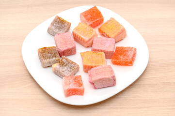 Sweet jelly marmalade on a white plate. Chewy and colorful.