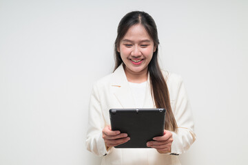 Portrait of young Asian woman wearing suit ready for business using digital tablet computer