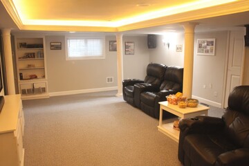 Finished basement home theater with comfortable seating.