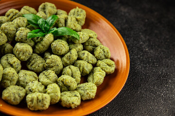 Gnocchi spinach potato dough second course portion size natural product tasty snack fresh delicious gourmet food background on the table rustic top view copy space
