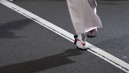 TOKYO, JAPAN - AUG 2025 : Slow motion shot of Awa Odori dance festival in Koenji. Powerful and energetic dance and music. Traditional Japanese summer event in Tokyo. Close up shot of dancer.