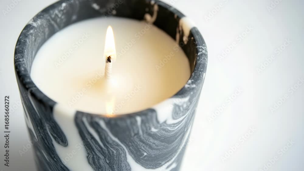 Aufkleber a single candle sits on a table with no other objects in sight, providing warm light and focus