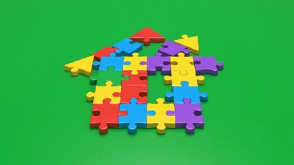 Building a dream home with colorful puzzle pieces represents real estate investment property solutions and teamwork for finding the perfect family housing concept - Powered by Adobe