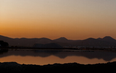 Orange sunset with mountain silhouettes in Ibiza