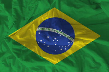 Stylized image of the Brazilian flag with a crumpled paper texture and halftone effect. Concept of...