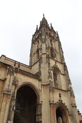 Fototapeta premium Gothic cathedral tower with ornate architectural details, pointed arches and stone spire, historic medieval church architecture and cultural heritage landmark in Spain
