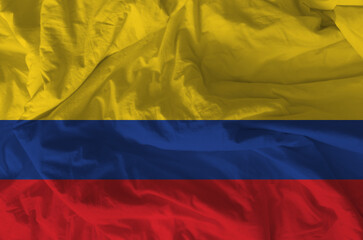 Stylized image of the Colombian flag with a crumpled paper texture and halftone effect. Concept of...