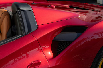 Partial side view of air intake in red sports car