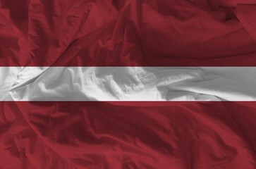 Stylized image of Latvian flag with crumpled paper texture and halftone effect. Concept of...