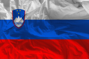 Stylized image of Slovenian flag with crumpled paper texture and halftone effect. Concept of...