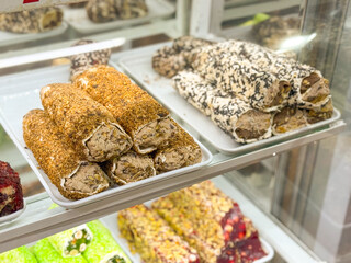 Bright candy turkish delight with nut filling arranged in a shop window. Confectionery, culture and culinary indulgence represented through gourmet sweets, tradition and consumer delight.