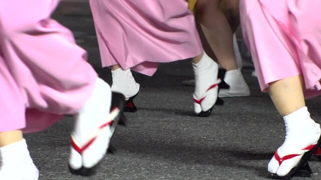 TOKYO, JAPAN - AUG 2025 : Slow motion shot of Awa Odori dance festival in Koenji. Powerful and energetic dance and music. Traditional Japanese summer event in Tokyo. Close up shot of dancer.