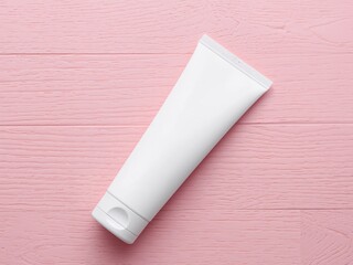 A White Tube On A Pastel Pink Wooden Surface Light And Clean Aesthetic.
