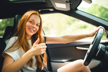 Beautiful young girl driver with with her white car