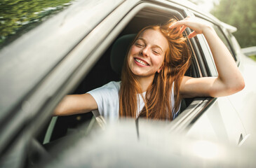 Beautiful young girl driver with with her white car