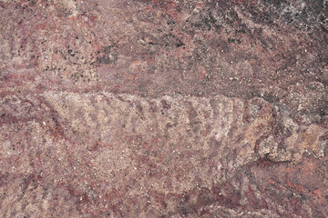 Ancient weathered red rock wall with natural wavy texture, pha taem national park