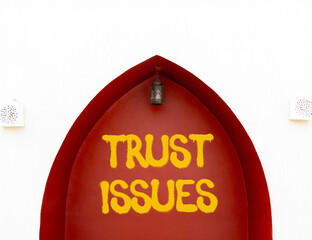 Trust issues symbol. Concept word Trust issues on beautiful white and red wall. Beautiful white and...