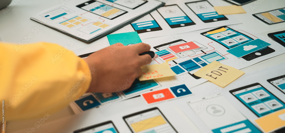 Aufkleber a close-up view of a hands-on mobile app design process featuring colorful sketches, notes, and prot
