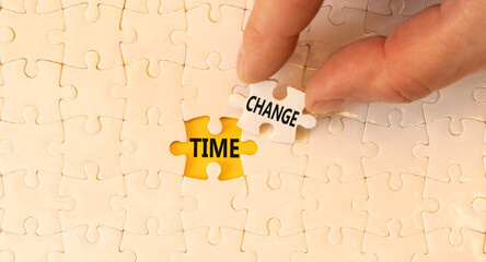 Time change symbol. Concept word Time change on beautiful white puzzles. Businessman's hand....