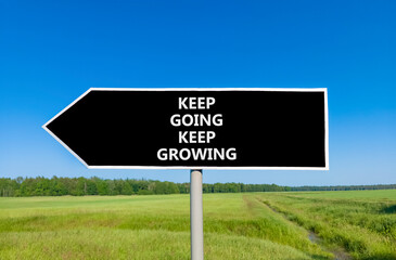 Keep going and growing symbol. Concept words phrase Keep going keep growing on beautiful road sign. Beautiful blue sky green grass lawn background. Business Keep going and growing concept. Copy space.