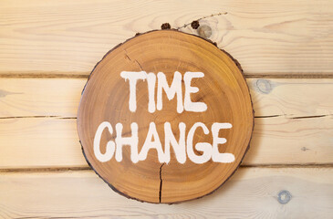 Time change symbol. Concept word Time change on beautiful wooden circle on wooden wall. Beautiful...