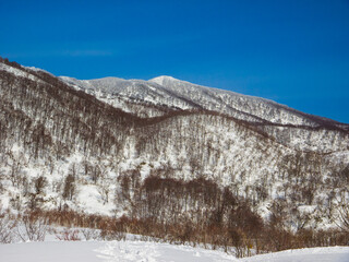 The Sekida Mountains on the border of Nagano and Niigata prefectures in the Japanese winter (Viewed from Togari Onsen, Nagano, Japan)