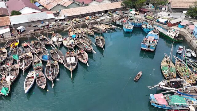 Drone shot of fishing boat arriving at Dhows Harbor, Stone Town, Zanzibar