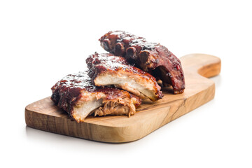Pork BBQ glazed ribs on cutting board isolated on white background.