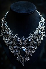 silver and natural black stones necklace isolated against a dark backdrop