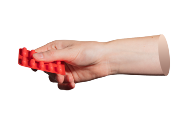 Closeup of hand with red blister pack. Representation of medical drugs, pills, and prescription