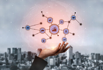 A futuristic digital network concept showcasing a hand holding various data visualization symbols against a blurred urban background, representing modern connectivity. Tessel