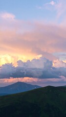 Blurry mountain range at sunset, soft clouds