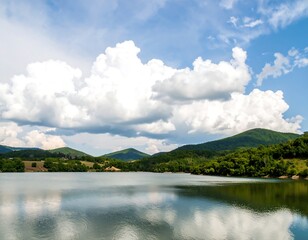 Serene lake scene with puffy clouds over hills