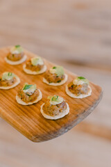 Delicious appetizer platter featuring savory meatballs on crispy crackers served at an upscale dining event