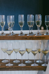 Elegant arrangement of wine glasses filled with white wine at a modern tasting event in the evening
