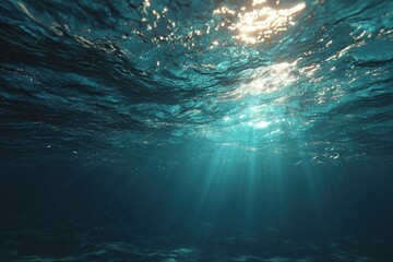 Obraz premium Rays of sunlight penetrate the ocean surface, creating a serene underwater atmosphere at midday in crystal clear water