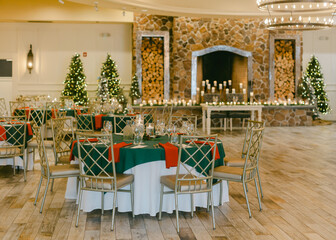 Elegant dining setup for festive celebration in beautifully decorated venue with warm lighting